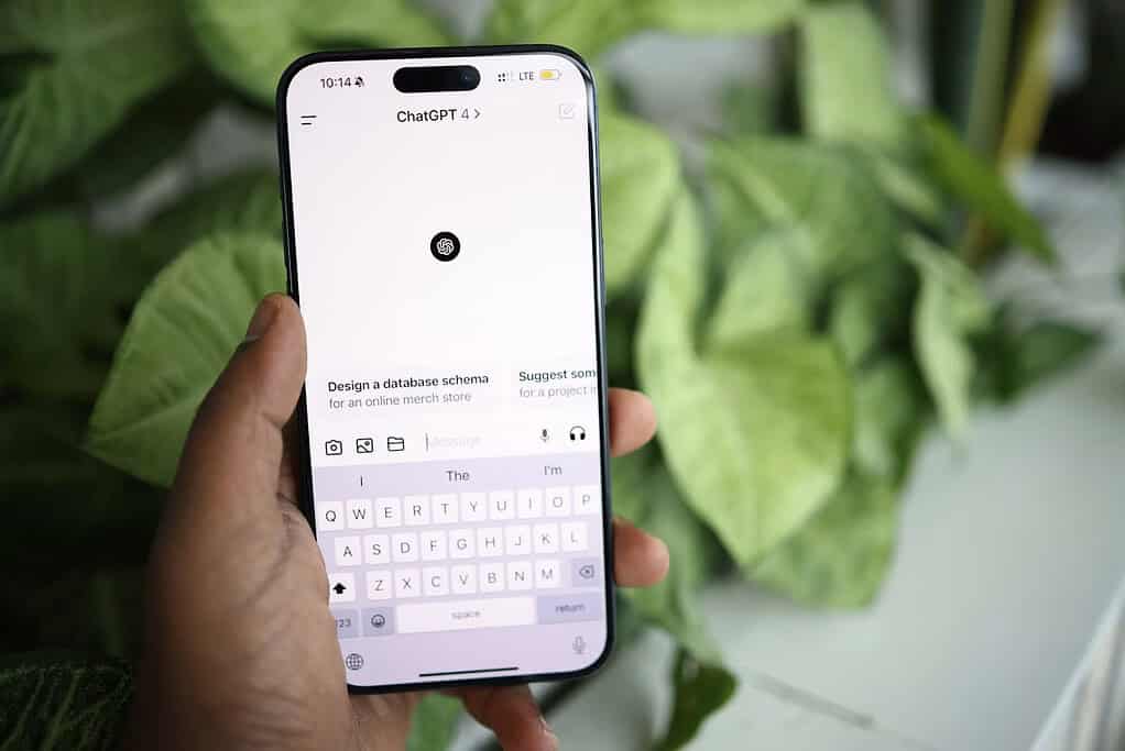 Person holding a smartphone with the ChatGPT mobile app open