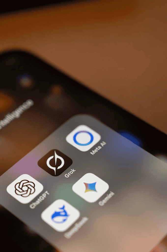 Smartphone screen showing AI assistant apps including ChatGPT, Grok, Meta AI, Gemini, and DeepSeek.
