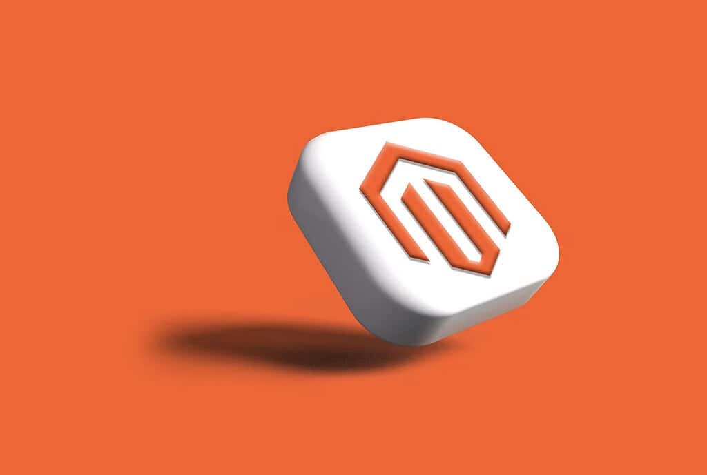 Three-dimensional Magento logo displayed on an orange background